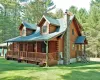 Back of property featuring a yard and covered porch