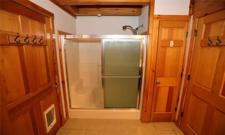 Bathroom featuring walk in shower and tile patterned floors