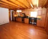 Kitchen with light wood-type flooring, pendant lighting, sink, stainless steel appliances, and a baseboard heating unit