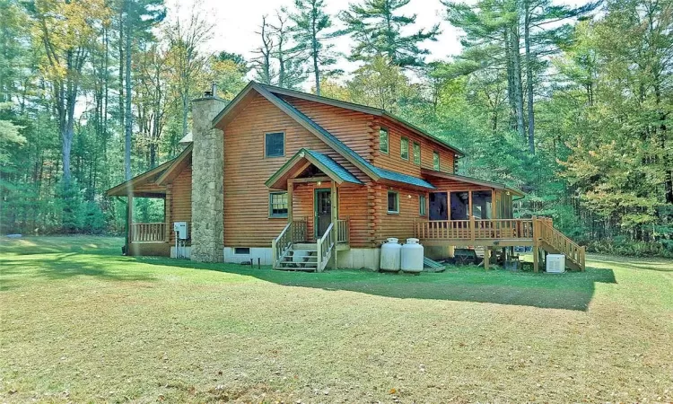 Back of house with a yard