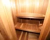 View of sauna / steam room with wood walls and hardwood / wood-style flooring