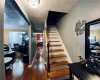 Staircase with ornamental molding and hardwood / wood-style floors