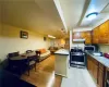 Kitchen featuring pendant lighting, kitchen peninsula, stainless steel appliances, and light hardwood / wood-style floors