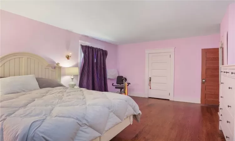 Bedroom featuring dark wood-type flooring