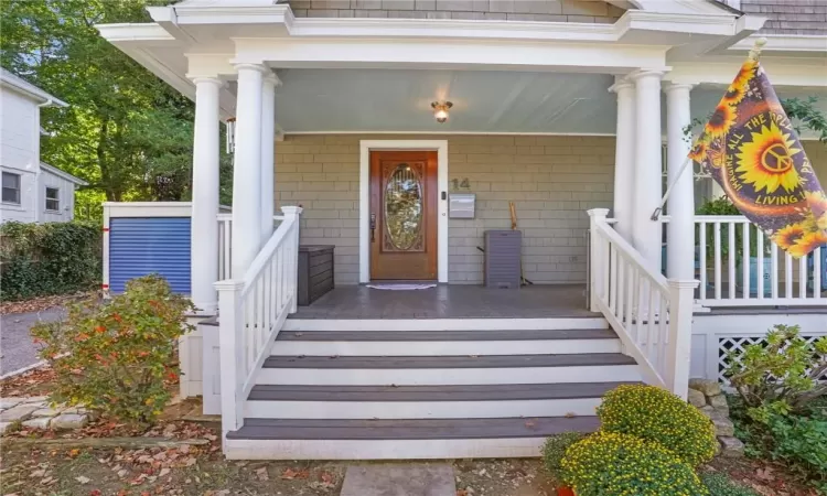 View of exterior entry with covered porch