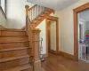 Staircase featuring ornamental molding and hardwood / wood-style flooring