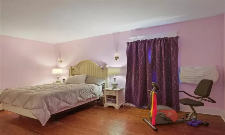 Bedroom featuring dark wood-type flooring