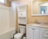 Full bathroom with toilet, vanity, and tub / shower combination