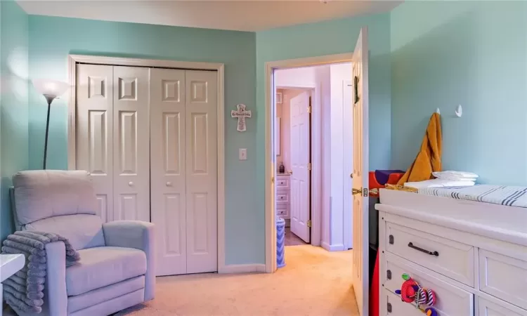 Bedroom featuring a closet and light colored carpet