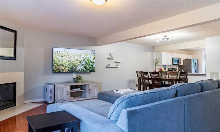 Living room with a fireplace and hardwood / wood-style floors