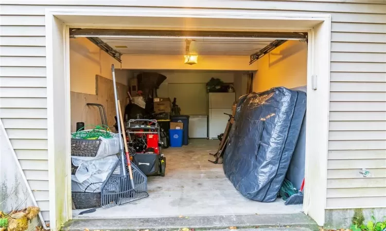 Garage featuring white fridge