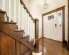 Elegant entrance foyer with original hardwood / wood-style stairway and flooring