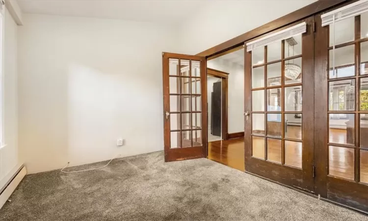 Empty room featuring french doors can be used as an office.