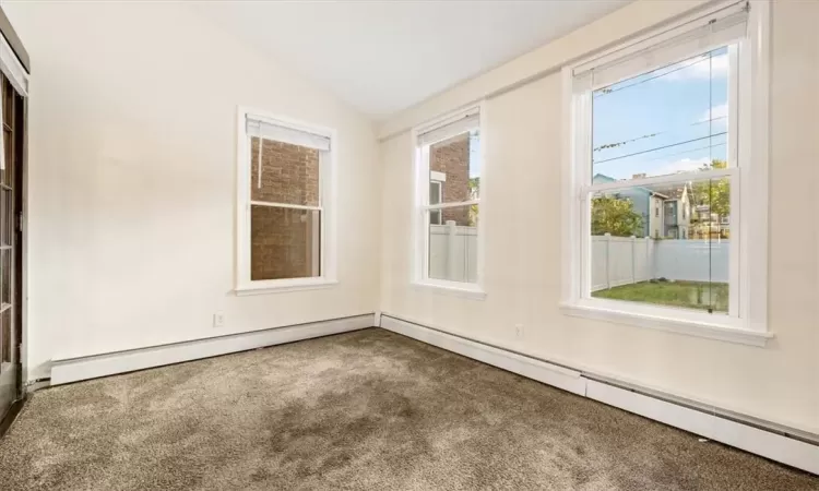 Spare room with carpet flooring. Located behind dining room.