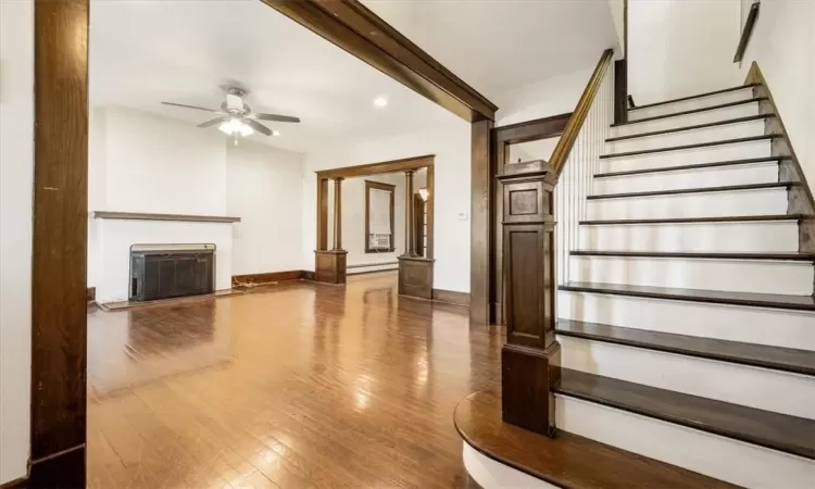 Preserved hardwood / wood-style floors leading from the living room to the 2nd floor.