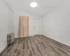 Unfurnished room featuring wood-type flooring and radiator