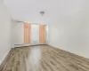 Spare room with baseboard heating and hardwood / wood-style floors