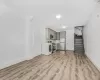 Unfurnished living room with washer / dryer and light hardwood / wood-style floors