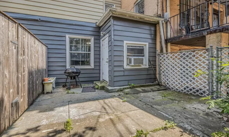 Back of house with a patio, a balcony, and cooling unit