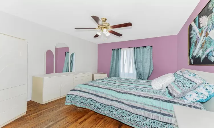 Bedroom featuring hardwood / wood-style floors and ceiling fan