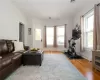 Living room with a healthy amount of sunlight and hardwood / wood-style flooring