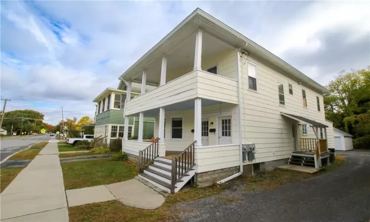 View of front of home featuring a porch and a balcony