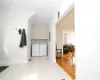 Laundry area featuring electric panel, washer and clothes dryer, and light wood-type flooring