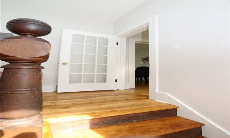 Stairs featuring hardwood / wood-style flooring