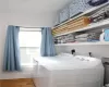 Laundry area with independent washer and dryer and hardwood / wood-style flooring