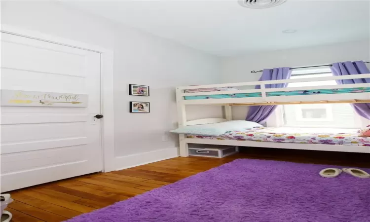 Bedroom with hardwood / wood-style floors