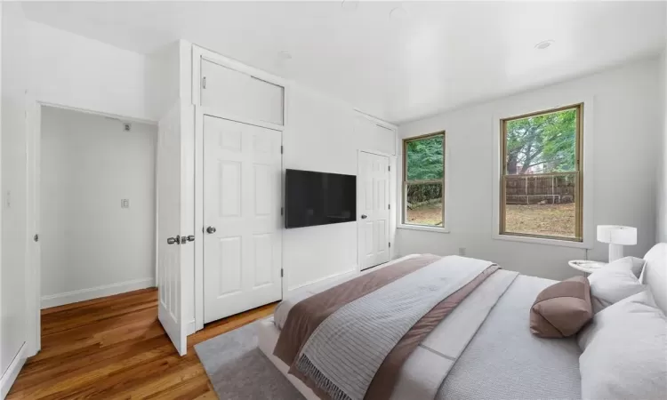 Bedroom with hardwood / wood-style flooring