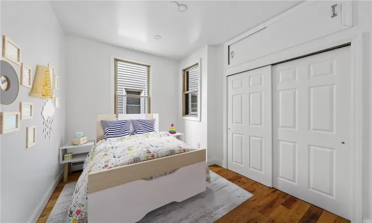 Bedroom featuring a closet and dark hardwood / wood-style flooring