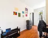 Home office with ornamental molding and wood-type flooring