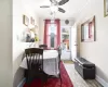 Dining area with crown molding, hardwood / wood-style flooring, and ceiling fan