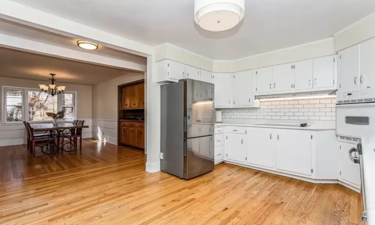 Large open kitchen layout flows into dining room.