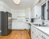 Kitchen with new refrigerator and tiled back splash.