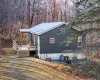 View of side of home with a wooden deck