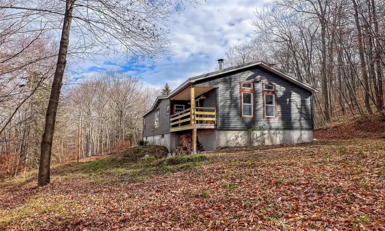 View of side of property featuring a covered porch.