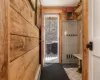 Mudroom with wooden walls and new tile.