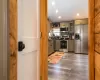 Kitchen with decorative backsplash, dark hardwood / wood-style flooring, and stainless steel appliances