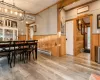 Dining area with wood walls, wood-type flooring, baseboard heating, and ornamental molding