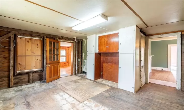 Spare room featuring wooden walls and hardwood / wood-style flooring