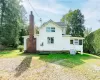 Rear view of house featuring a lawn