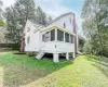 View of property exterior featuring a yard and a sunroom