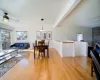 Living room with stone, floor to ceiling wood burning fireplace.