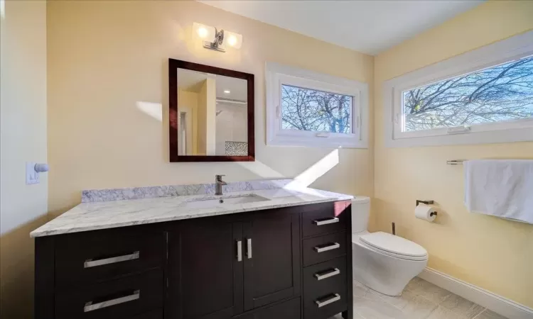 Bathroom featuring walk in shower, soaking tub, tile flooring, and vanity with dual sinks.