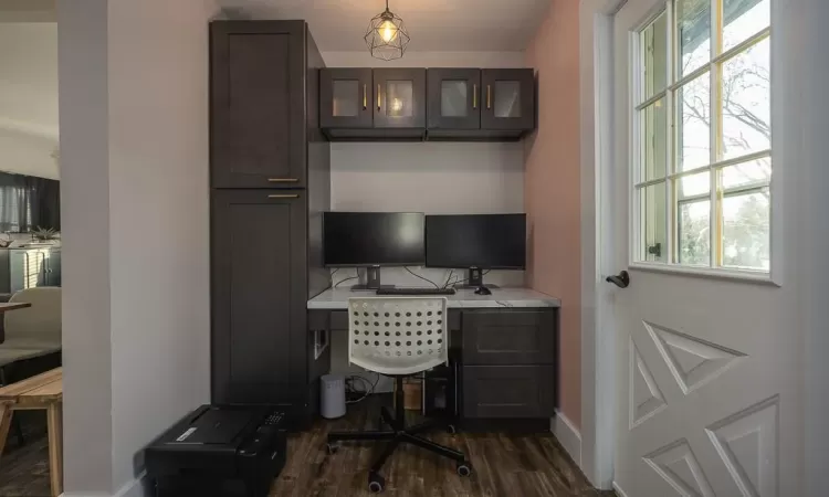 Office space with dark wood-type flooring