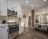 Kitchen with white cabinetry and stainless steel appliances