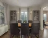 Dining room with dark hardwood / wood-style floors and radiator heating unit