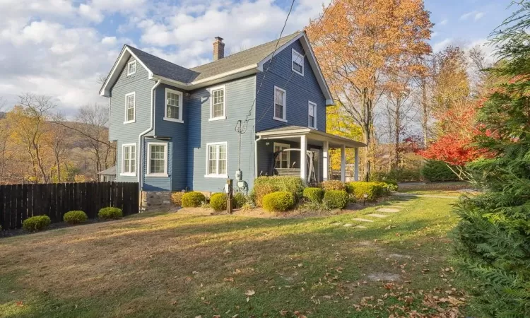 View of side of property with a yard